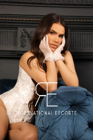 Sexy brunette escort wearing white lace gloves 