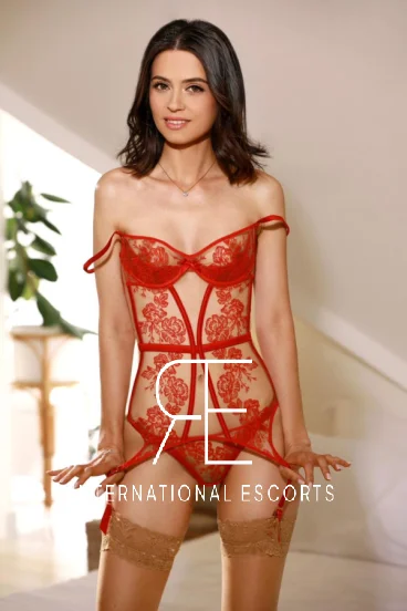 Issa is pictured wearing a red and beige lace basque 