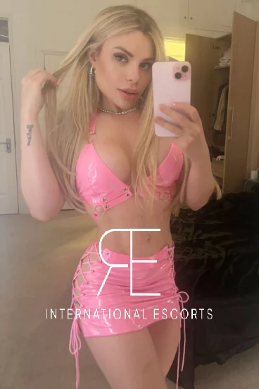 A selfie of a very sexy blonde London escort from Brazil wearing pink 