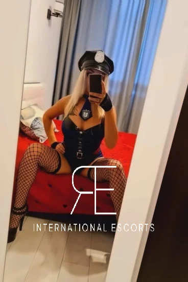 Sexy London escort Aria is pictured wearing a police uniform 