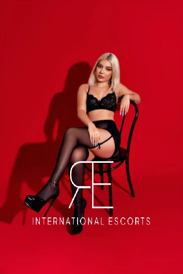 London escort wearing black lingerie sitting in a chair looking very sexy 