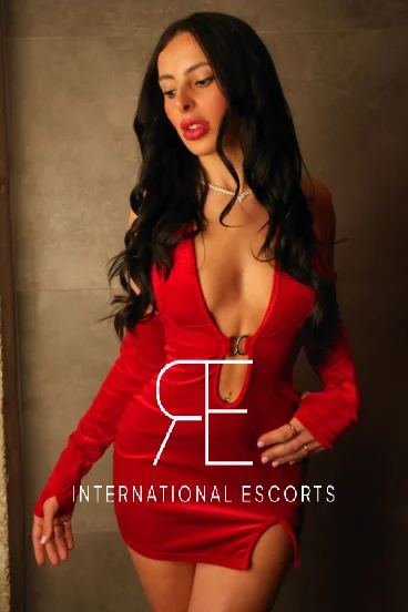 South American London escort Marigold is wearing a red dress 