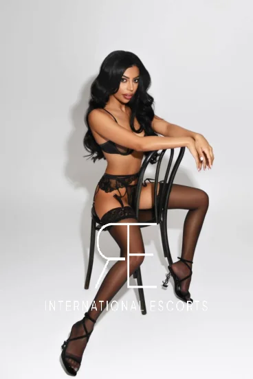 Brazilian London escort straddling a chair 