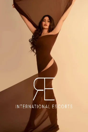 London escort Anitta wearing a brown dress 