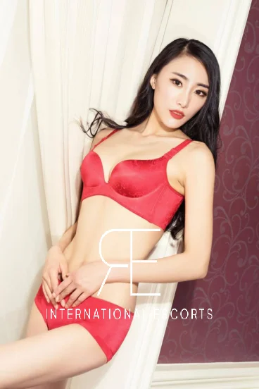 Asian escort London wearing red lingerie and she has red lips to match 