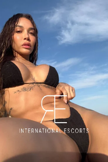 Francesca has wet hair and is wearing a sexy black bikini in this photo 