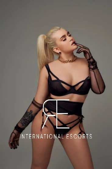 Blonde escort Amaris is pictured dressed in black lingerie 