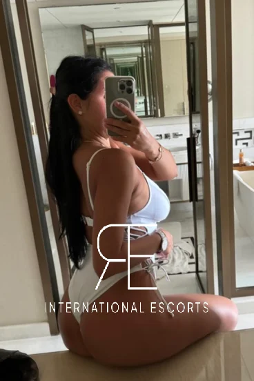 Aylin looks very sexy wearing a white swimsuit with a thonged back 