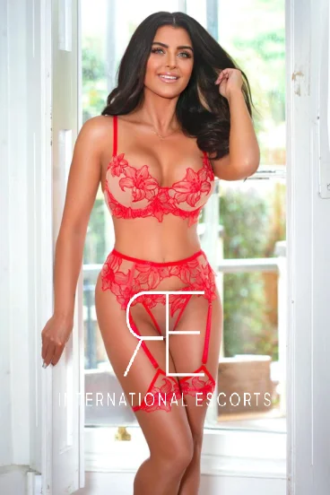 Mature London escort wearing a sexy red lingerie set 