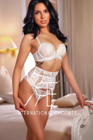 Young escort Layla is pictured wearing white lace lingerie 