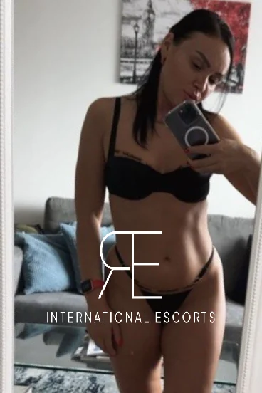 Selfie of a very sexy escort named Julie standing in the mirror 