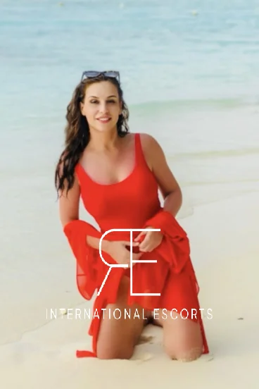 Sexy escort from the Ukraine wearing a red swim suit 