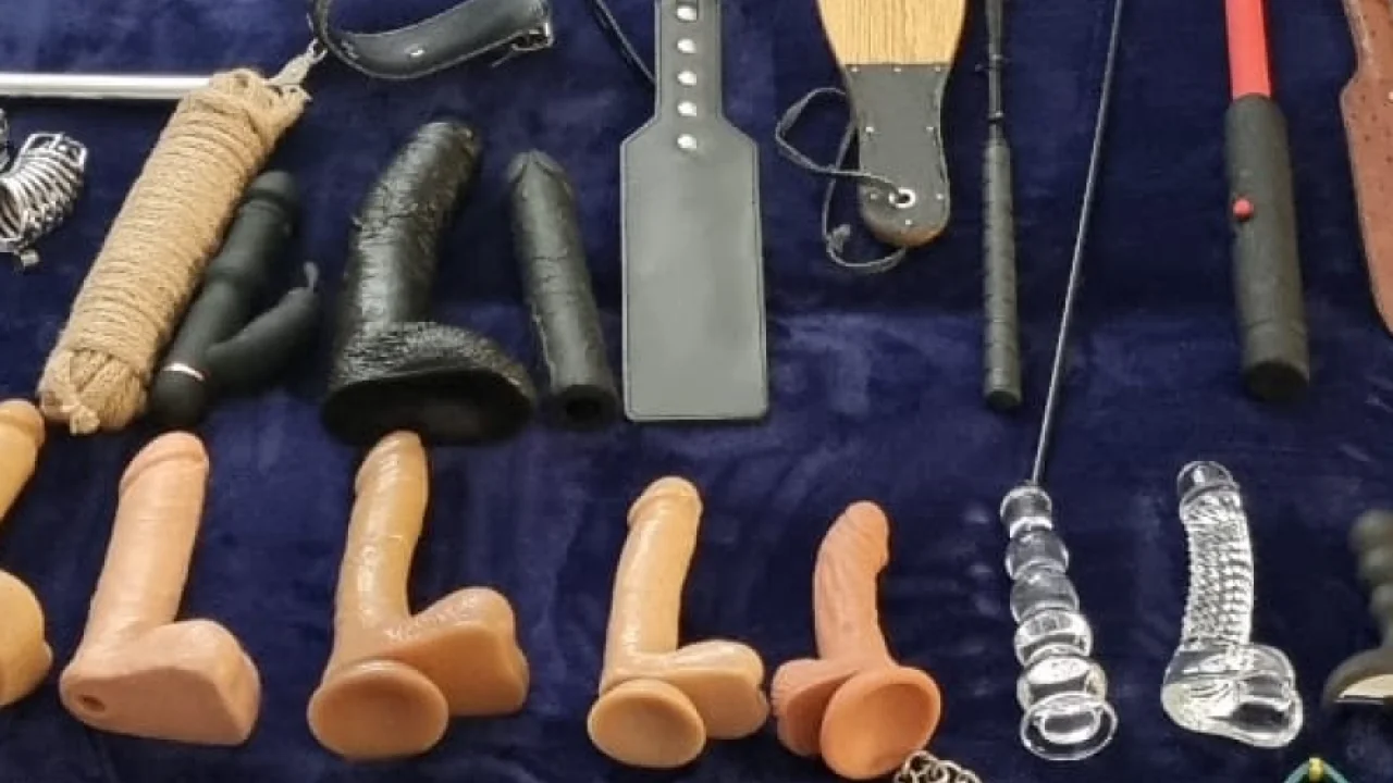 Sex toys laid out on a bed 