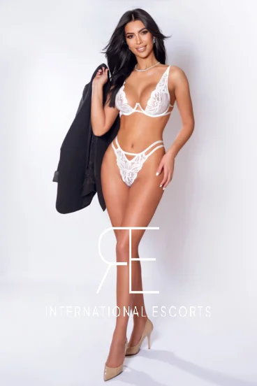 London escort pictured wearing white lace lingerie and high heels 