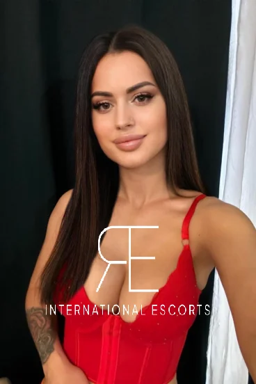 Selfie of sexy young London escort Pupi wearing a red top 