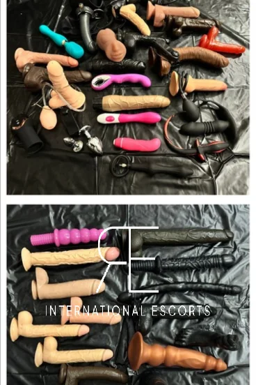 Lots of sex toys laying out on a bed 