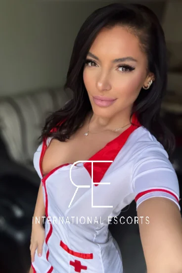 Kylie looks sexy dressed in a white latex nurse outfit 