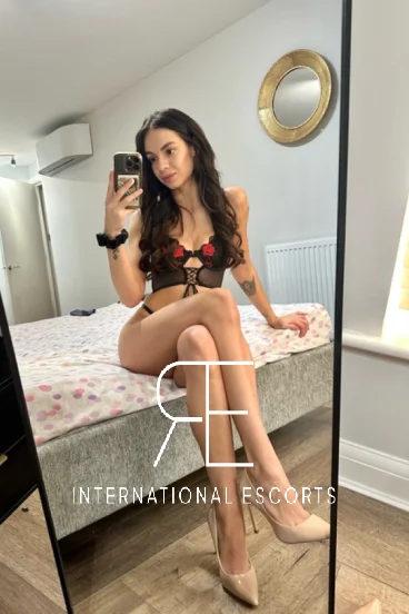 Bayswater escort Angelica  sitting on her bed 