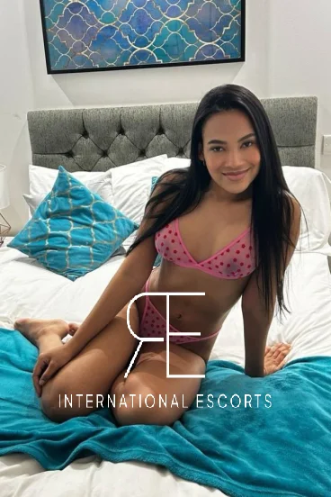 Brazilian London escort Cameo sat on her bed 