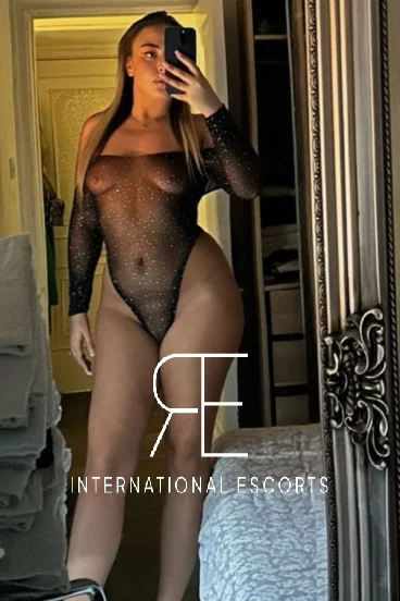 Sexy blonde London escort wearing fishnet 