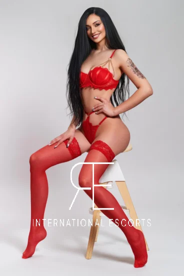 Busty London escort wearing red lingerie 